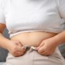 Person struggling with weight loss mistakes and tight pants